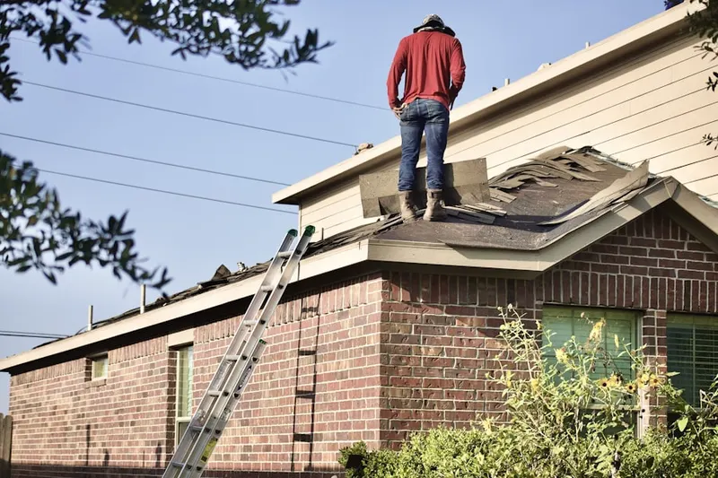 Professional roofer working on a residential roof in Centereach